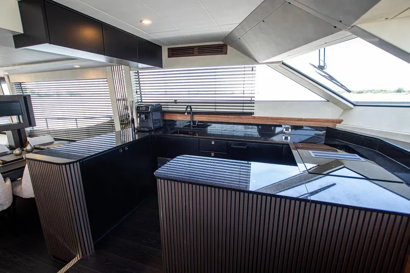  Yacht Photos Pics Luxurious kitchen interior of 2024 Van der Heijden Phantom Expedition yacht, featuring sleek black countertops.