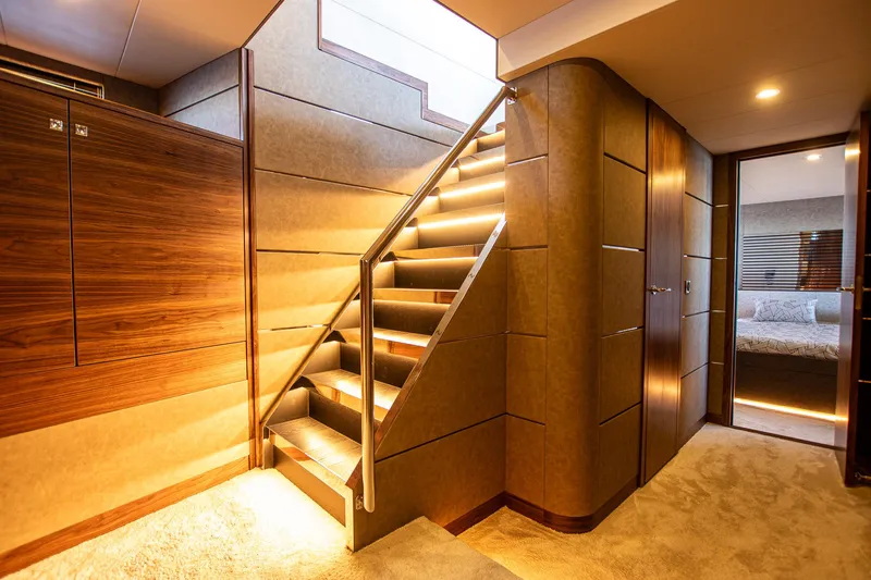  Yacht Photos Pics Luxurious interior of 2024 Van der Heijden Phantom Expedition yacht with illuminated staircase.