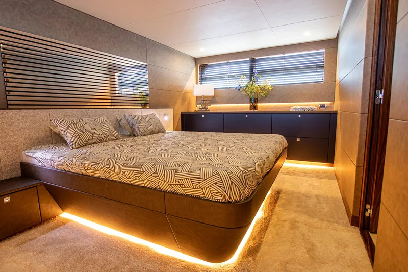  Yacht Photos Pics Luxurious bedroom interior on 2024 Van der Heijden Phantom Expedition yacht, featuring modern design and ambient lighting.