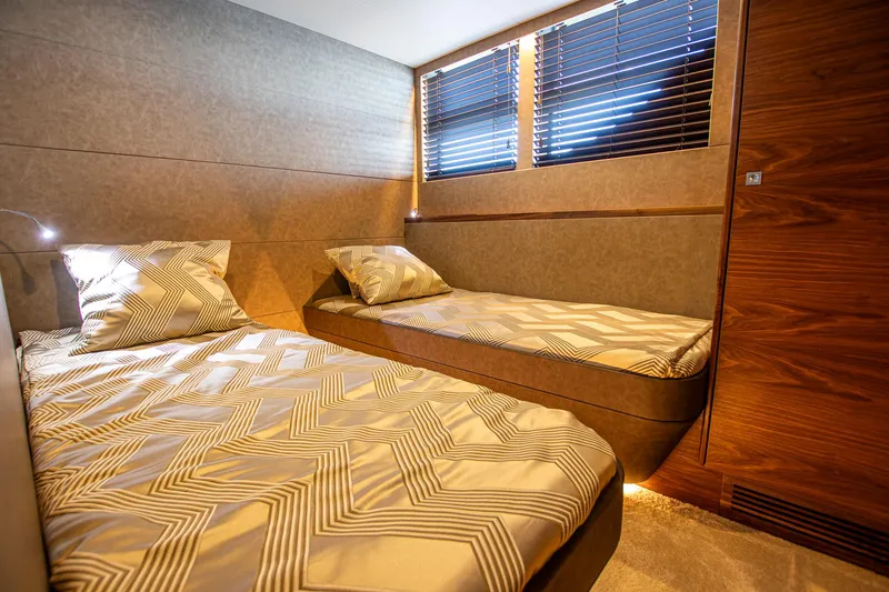  Yacht Photos Pics Luxurious twin cabin in 2024 Van der Heijden Phantom Expedition yacht, featuring modern bedding and wood accents.