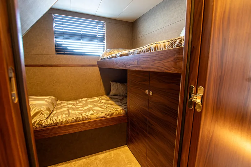  Yacht Photos Pics 2024 Van der Heijden Phantom Expedition yacht cabin with wooden bunk beds and window blinds.
