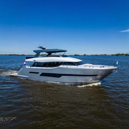  Yacht Photos Pics 2024 Van der Heijden Phantom Expedition yacht cruising on open water under clear blue skies.