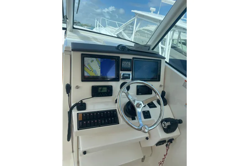  Yacht Photos Pics Helm of 2016 Pursuit DC 325 Dual Console with navigation screens and controls.