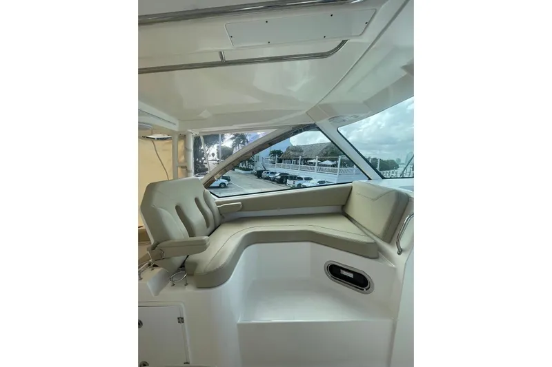  Yacht Photos Pics 2016 Pursuit DC 325 Dual Console interior with beige seating and large windows.