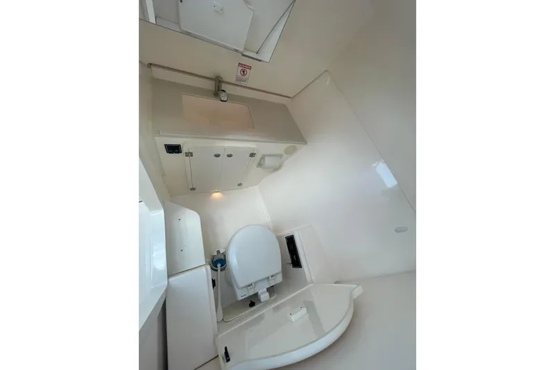  Yacht Photos Pics Interior of 2016 Pursuit DC 325 Dual Console boat bathroom with sink and toilet.