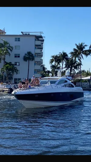 Pura Vida Yacht Photos Pics 2007 Sunseeker Predator 72 yacht on water with passengers.