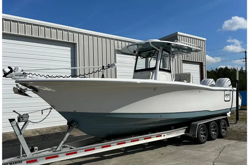  Yacht Photos Pics 2022 Sea Hunt Gamefish 30 Coffin Box boat on trailer, parked outside a warehouse.