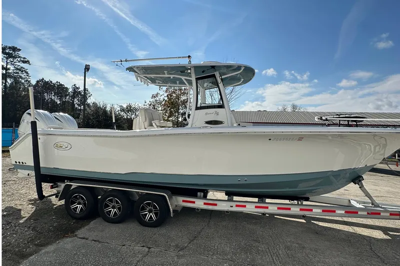  Yacht Photos Pics 2022 Sea Hunt Gamefish 30 Coffin Box boat on trailer under clear sky.