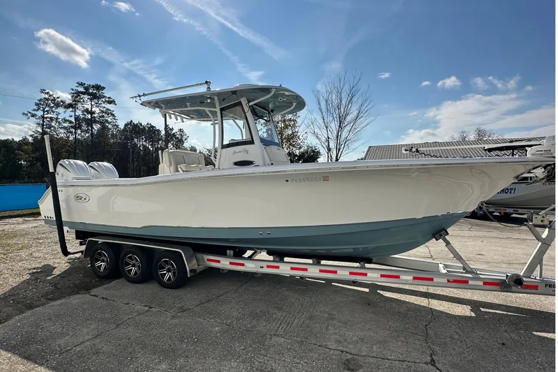  Yacht Photos Pics 2022 Sea Hunt Gamefish 30 Coffin Box boat on trailer, parked outdoors.