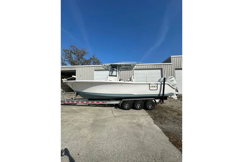  Yacht Photos Pics 2022 Sea Hunt Gamefish 30 Coffin Box boat on trailer, parked outdoors.