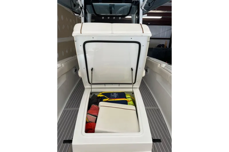  Yacht Photos Pics 2022 Sea Hunt Gamefish 30 Coffin Box with open storage compartment, showcasing life jackets.