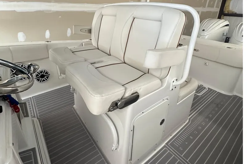  Yacht Photos Pics 2022 Sea Hunt Gamefish 30 Coffin Box boat interior with white seating and steering wheel.