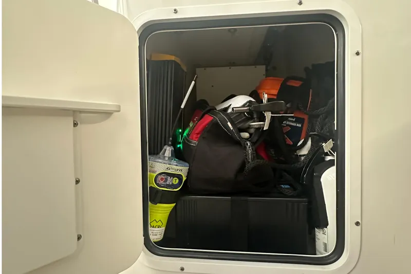  Yacht Photos Pics Storage compartment of 2022 Sea Hunt Gamefish 30 Coffin Box, filled with boating gear.