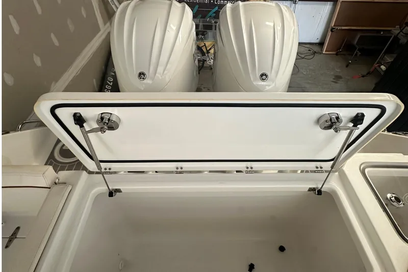  Yacht Photos Pics 2022 Sea Hunt Gamefish 30 Coffin Box with open storage compartment and dual engines.