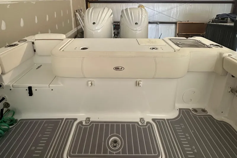  Yacht Photos Pics 2022 Sea Hunt Gamefish 30 Coffin Box interior with dual engines in a garage setting.