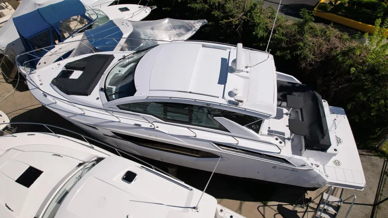 2024 Cruisers 42 Cantius Yacht Photos Pics 2024 Cruisers Yachts 42 Cantius luxury motor yacht docked among other boats.