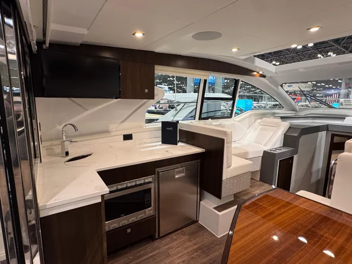 2024 Cruisers 42 Cantius Yacht Photos Pics Luxurious interior of 2024 Cruisers Yachts 42 Cantius with modern kitchen and seating area.