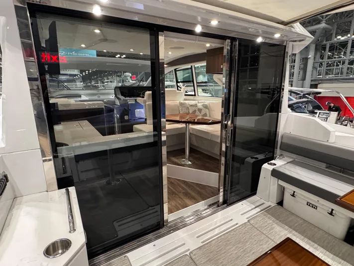 2024 Cruisers 42 Cantius Yacht Photos Pics 2024 Cruisers Yachts 42 Cantius interior with sliding glass doors and modern seating area.