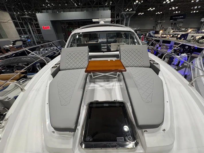 2024 Cruisers 42 Cantius Yacht Photos Pics 2024 Cruisers Yachts 42 Cantius with luxurious deck seating and table at a boat show.