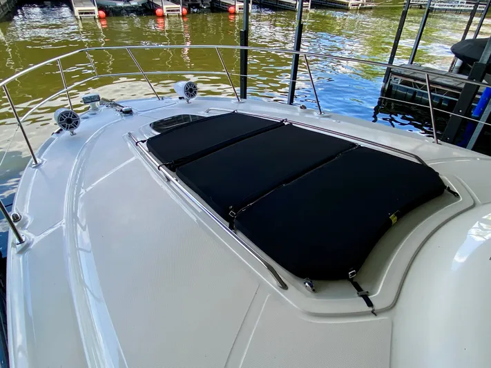  Yacht Photos Pics 2008 Sea Ray 38 Sundancer boat deck with black sun pads, docked by the water.