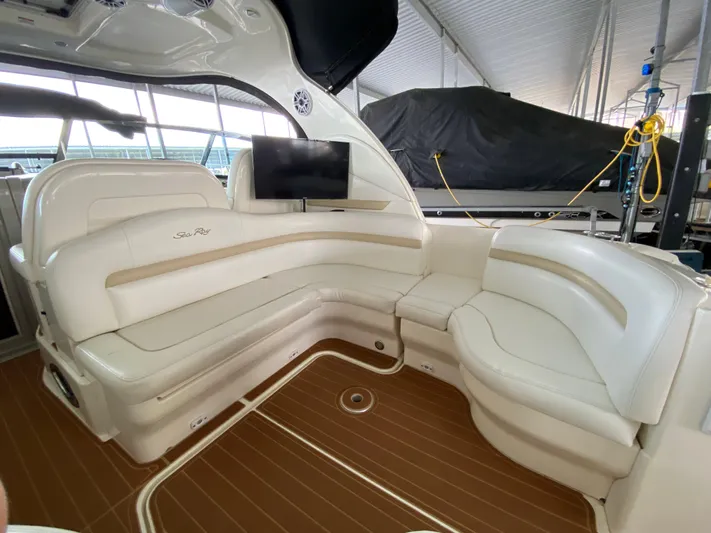  Yacht Photos Pics Luxurious interior of 2008 Sea Ray 38 Sundancer with white leather seating and wood flooring.
