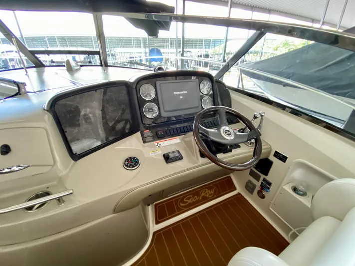  Yacht Photos Pics 2008 Sea Ray 38 Sundancer helm with steering wheel and navigation controls.