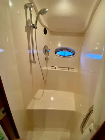  Yacht Photos Pics Luxurious shower area in 2008 Sea Ray 38 Sundancer yacht, featuring sleek design and porthole window.
