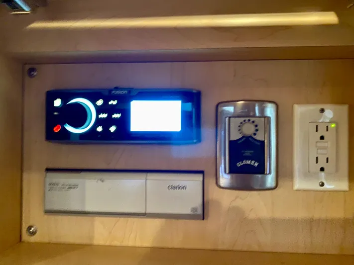  Yacht Photos Pics Control panel inside 2008 Sea Ray 38 Sundancer, featuring Fusion stereo and Glomex antenna controls.