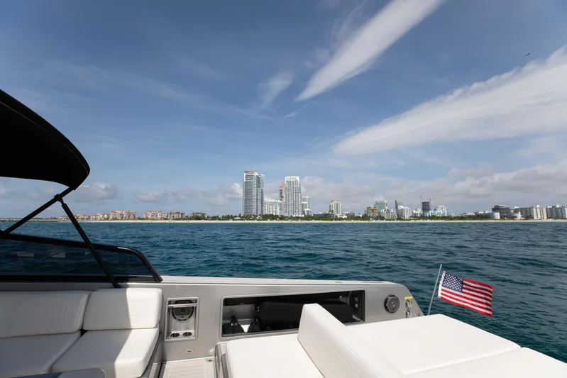 M/y 55 Van Dutch Yacht Photos Pics VanDutch 55 yacht cruising near a city skyline, American flag visible, 2017 model.
