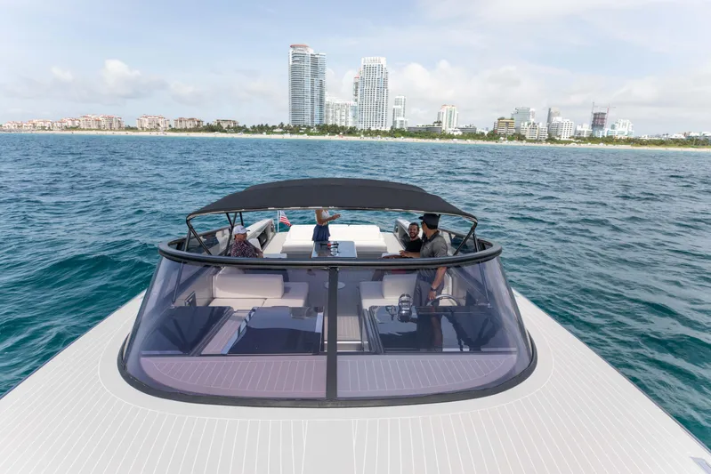 M/y 55 Van Dutch Yacht Photos Pics VanDutch 55 yacht cruising near city skyline, 2017 model, with passengers enjoying the view.
