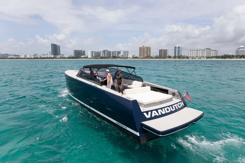M/y 55 Van Dutch Yacht Photos Pics VanDutch 55 yacht cruising near city skyline, 2017 model, in clear blue waters.