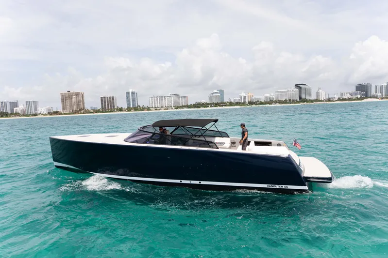 M/y 55 Van Dutch Yacht Photos Pics VanDutch 55 yacht cruising in turquoise waters near a city skyline, 2017 model.