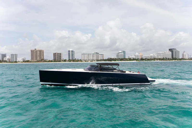 M/y 55 Van Dutch Yacht Photos Pics VanDutch 55 yacht cruising on turquoise waters, city skyline in background, 2017 model.