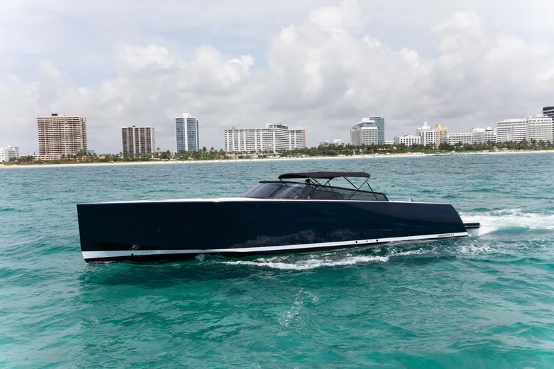M/y 55 Van Dutch Yacht Photos Pics VanDutch 55 yacht cruising on ocean with city skyline in background, 2017 model.