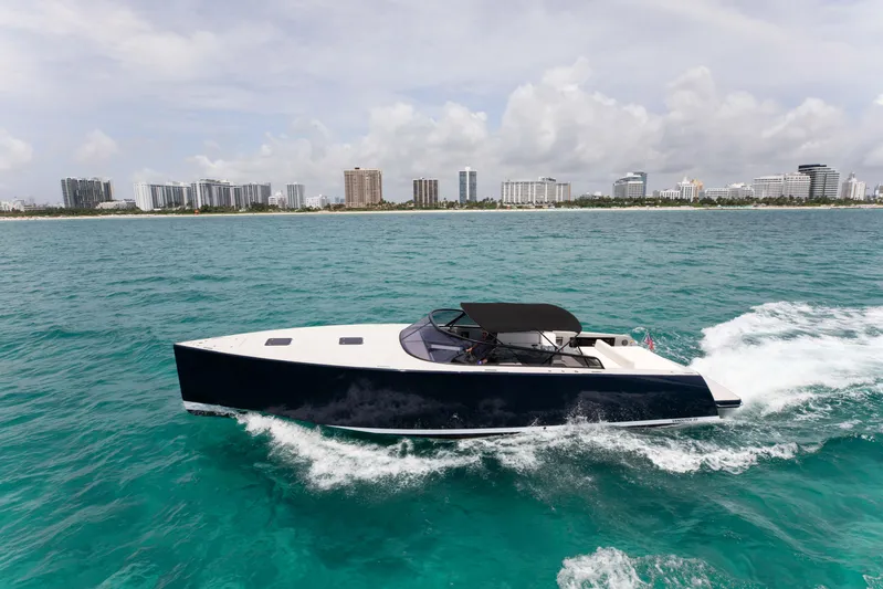 M/y 55 Van Dutch Yacht Photos Pics VanDutch 55 yacht cruising on turquoise waters near a city skyline, 2017 model.