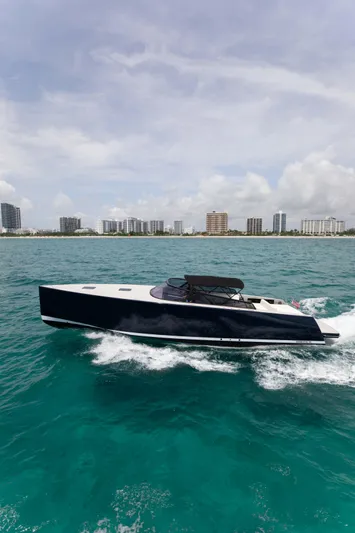 M/y 55 Van Dutch Yacht Photos Pics VanDutch 55 yacht cruising on turquoise waters near a city skyline, 2017 model.
