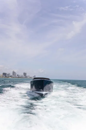 M/y 55 Van Dutch Yacht Photos Pics VanDutch 55 yacht cruising on open water, 2017 model, city skyline in background.