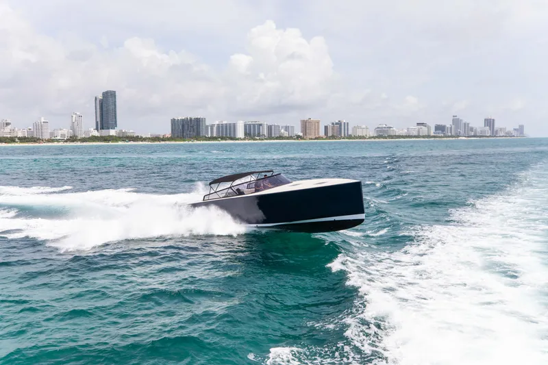 M/y 55 Van Dutch Yacht Photos Pics 2017 VanDutch 55 yacht cruising on ocean near city skyline.