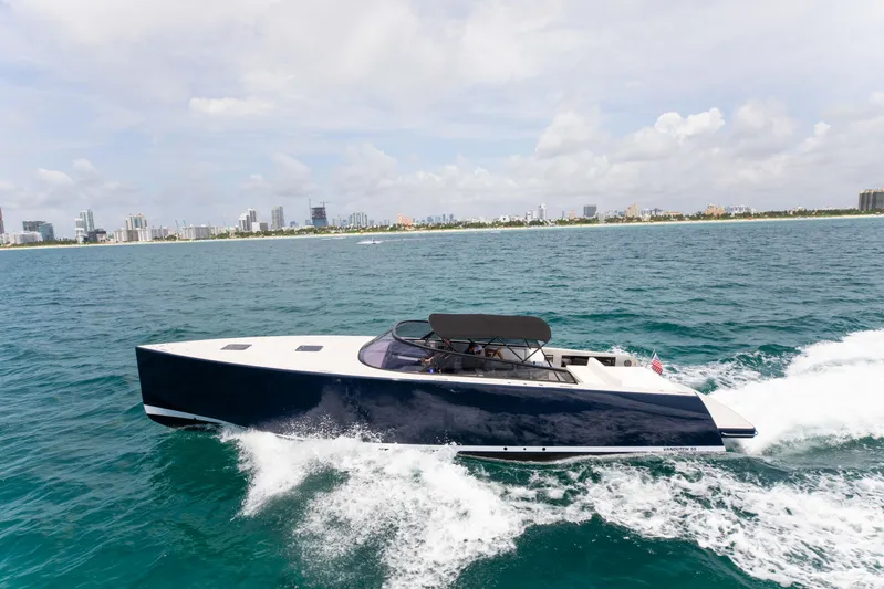 M/y 55 Van Dutch Yacht Photos Pics VanDutch 55 yacht cruising on open water, city skyline in background, 2017 model.