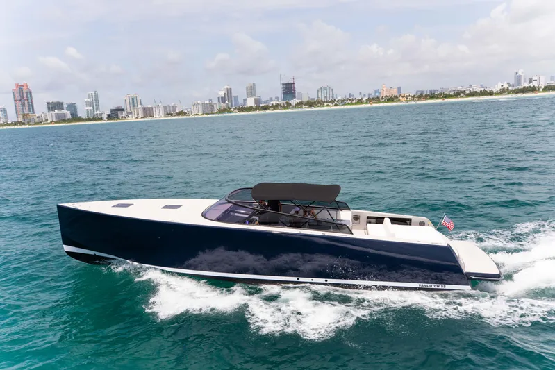 M/y 55 Van Dutch Yacht Photos Pics 2017 VanDutch 55 yacht cruising on ocean near city skyline.