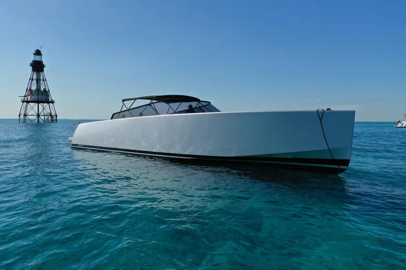 M/y 55 Van Dutch Yacht Photos Pics 2017 VanDutch 55 yacht on clear blue water near a lighthouse.