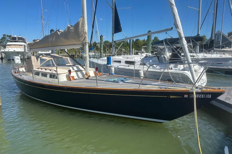 Ibis Yacht Photos Pics 2006 Morris M36 sailboat docked at a marina under clear blue skies.