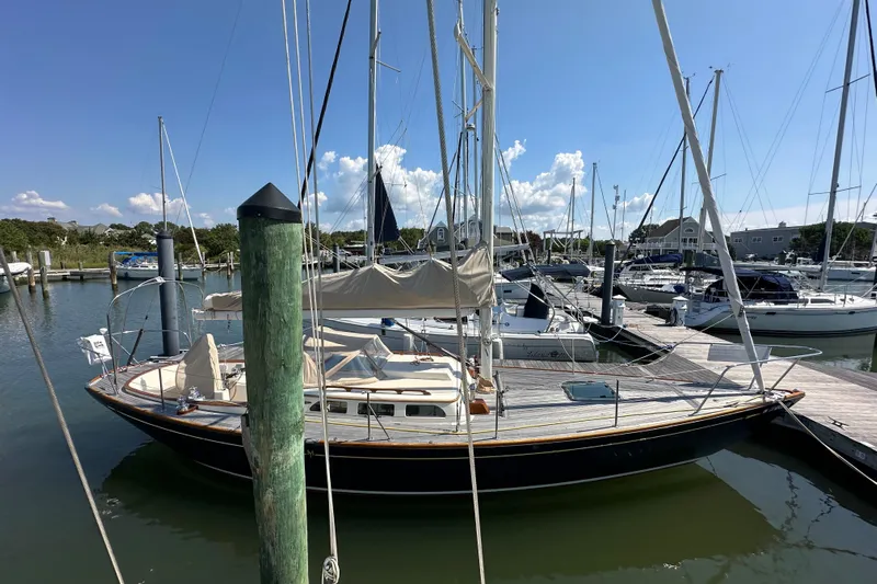 Ibis Yacht Photos Pics Sailboat docked in marina, Morris M36, 2006 model, under clear blue sky.