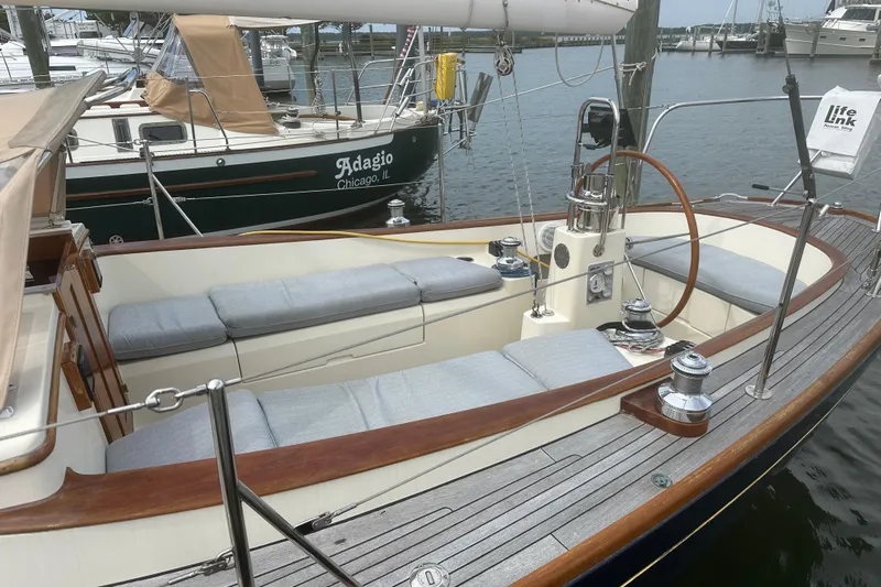 Ibis Yacht Photos Pics 2006 Morris M36 sailboat with wooden deck and cushioned seating in a marina.