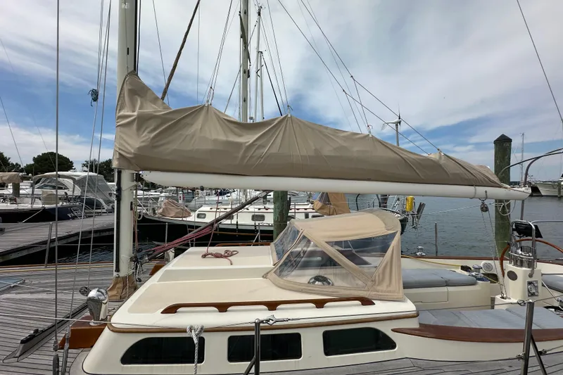 Ibis Yacht Photos Pics Sailboat docked at marina, Morris M36, 2006 model, with covered sail and clear sky.