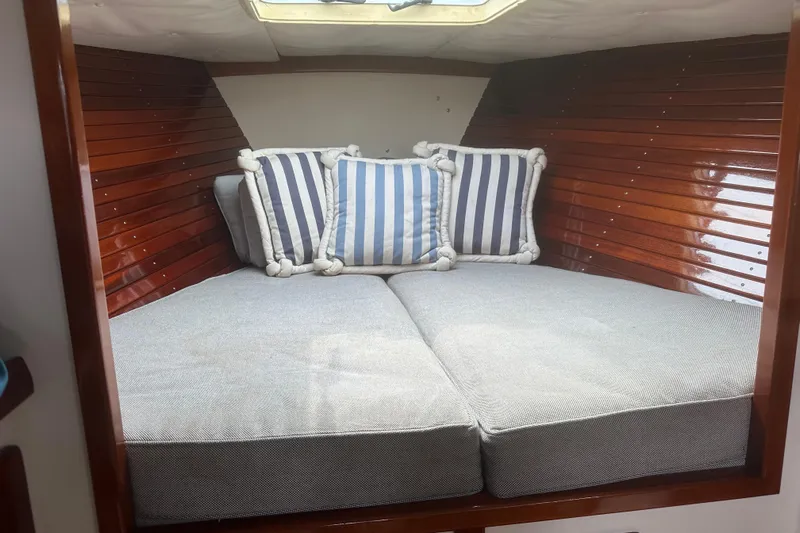 Ibis Yacht Photos Pics Cozy cabin interior of 2006 Morris M36 with striped cushions and wooden paneling.