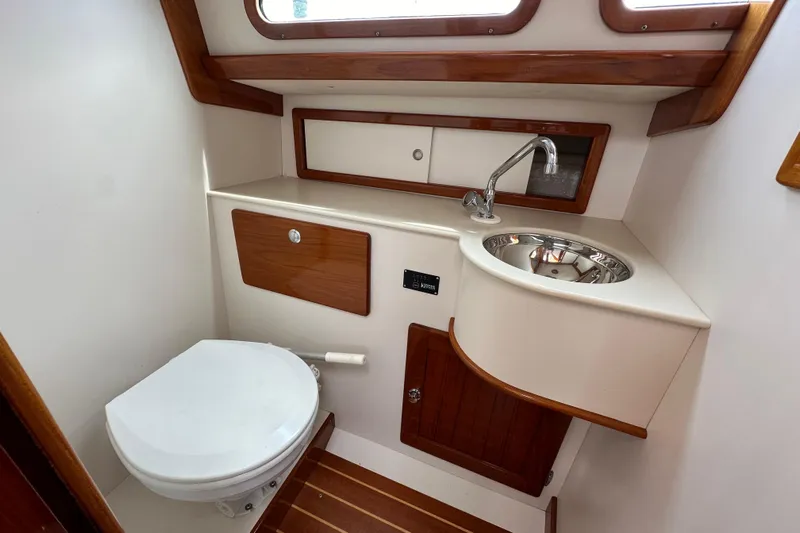 Ibis Yacht Photos Pics Compact bathroom in 2006 Morris M36 yacht with sink, toilet, and wooden accents.