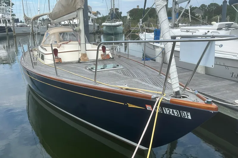 Ibis Yacht Photos Pics 2006 Morris M36 sailboat docked in a marina, featuring a sleek design and wooden deck.