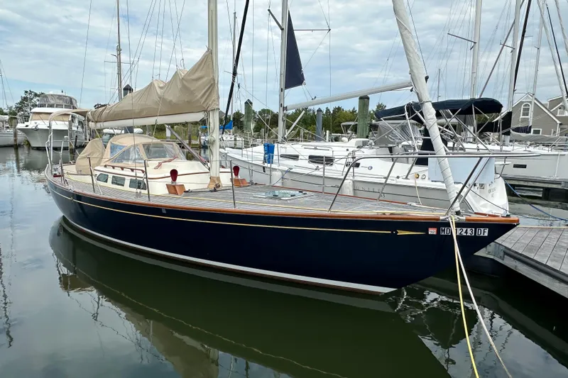 Ibis Yacht Photos Pics Sailboat Morris M36, 2006 model, docked in a marina with other boats.