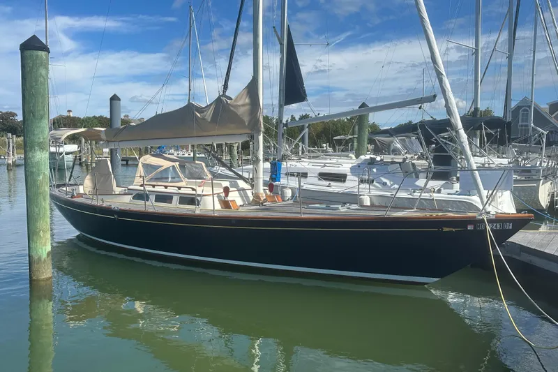 Ibis Yacht Photos Pics Sailboat docked in marina, Morris M36, 2006 model, under clear blue sky.